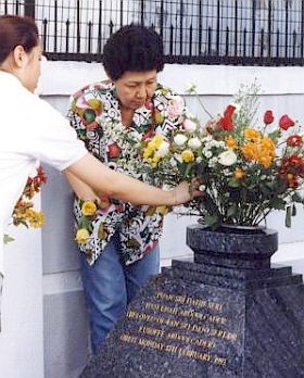 Saying goodbye: Haseenah’s granddaughter Christina (left) and daughter Julie placing flowers on her grave on the third anniversary of her death.