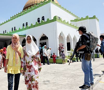 Watchful eyes: Policemen guarding the Semporna Mosque at Kampung Seri Jaya in Simunul, where the killings took place. — Bernama