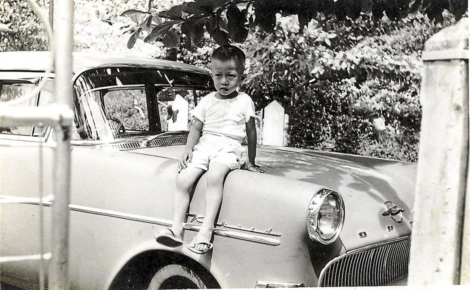 A young WCW posing on a car at his home in Jln Kampung Melayu in Air Itam - Recopy pix of Ayer Itam