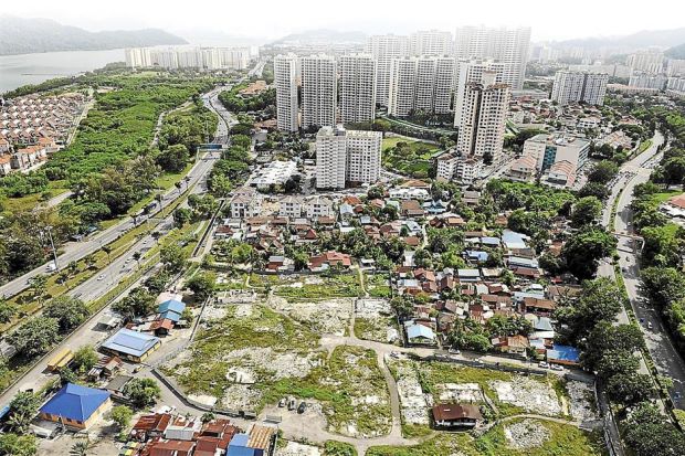 Changing landscape: The original Kampung Batu Uban is overshadowed by new condominiums and apartments being built in the area.