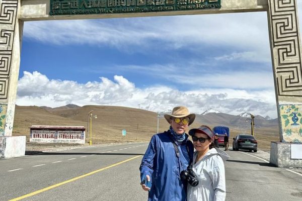 Below the arch of the gateway into the Mount Everest national park which has the Tibetan name of Chomolungma or Goddess Mountain of the World. With Florence Teh. We already had problems breathing as this picture was taken as the air was thin.